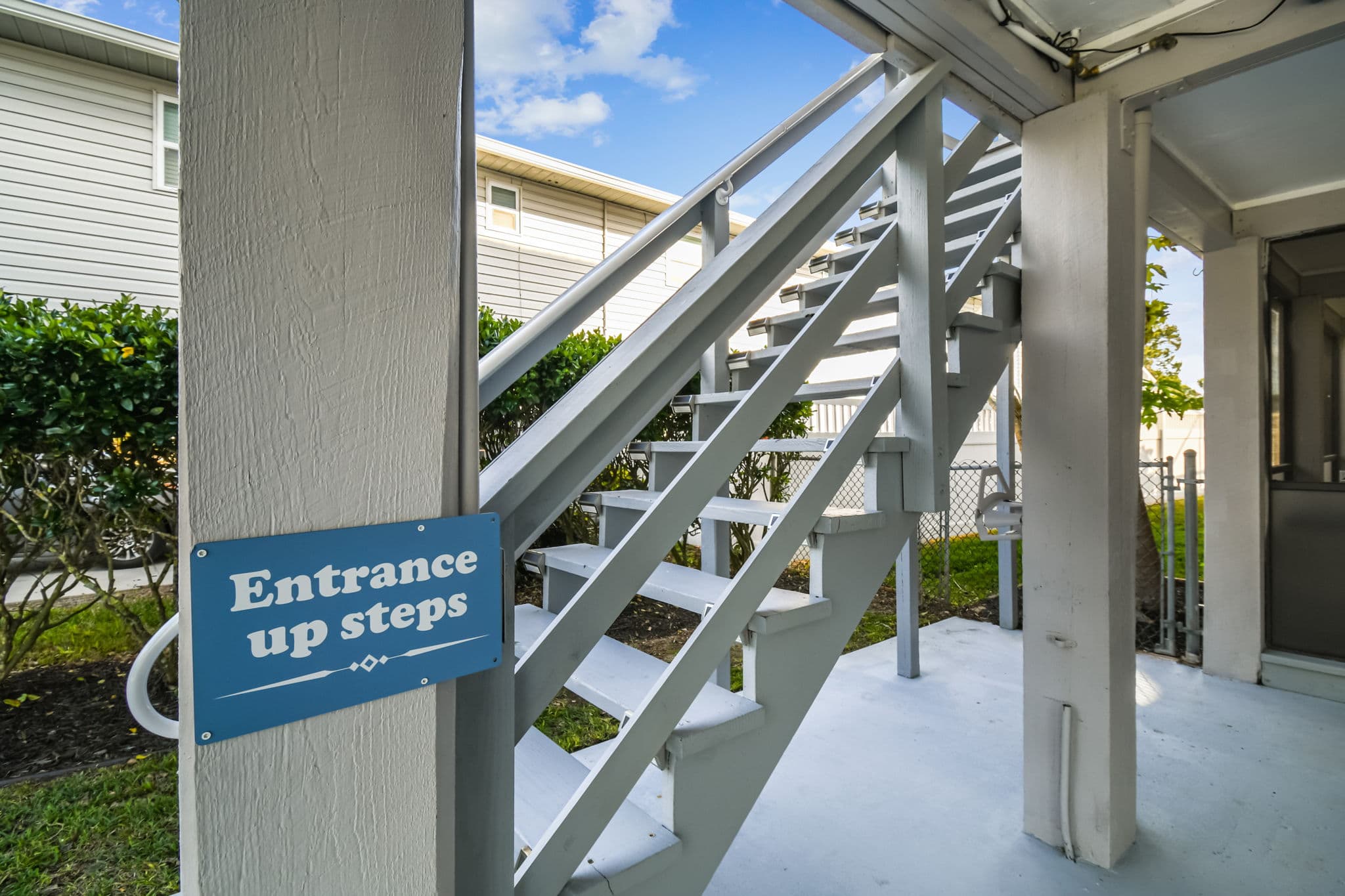 Elevated coastal home with stairs between levels (no elevator).