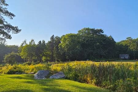 The cabin is set on 1.5 acres, with a tranquil babbling brook running through the property