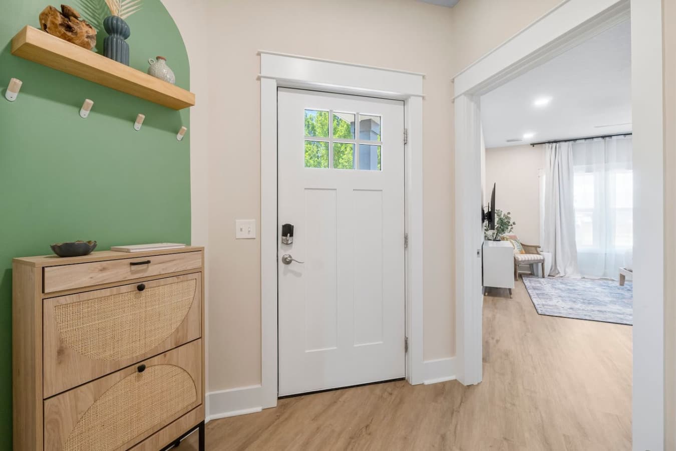 A nice entryway with an smart door lock on the front door and main floor King bedroom to the right.