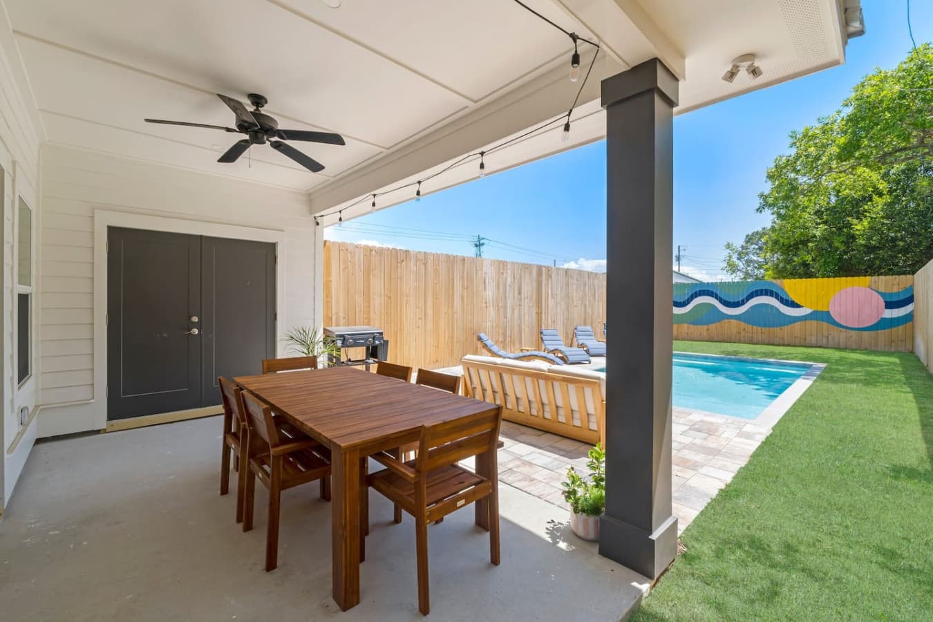 A great outdoor area to hang out, complete with a dining table and salt water pool