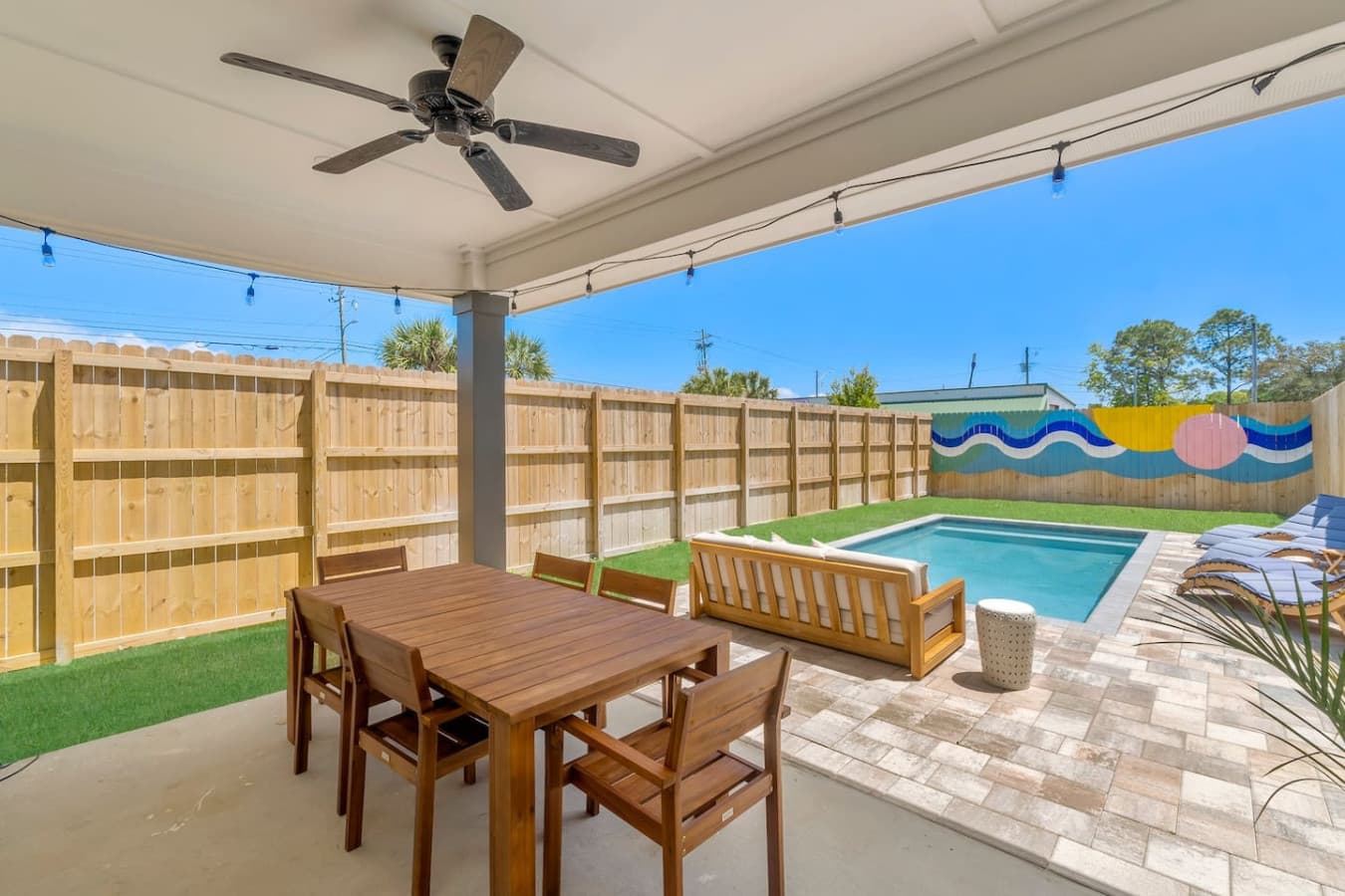 A great outdoor area to hang out, complete with a dining table and salt water pool