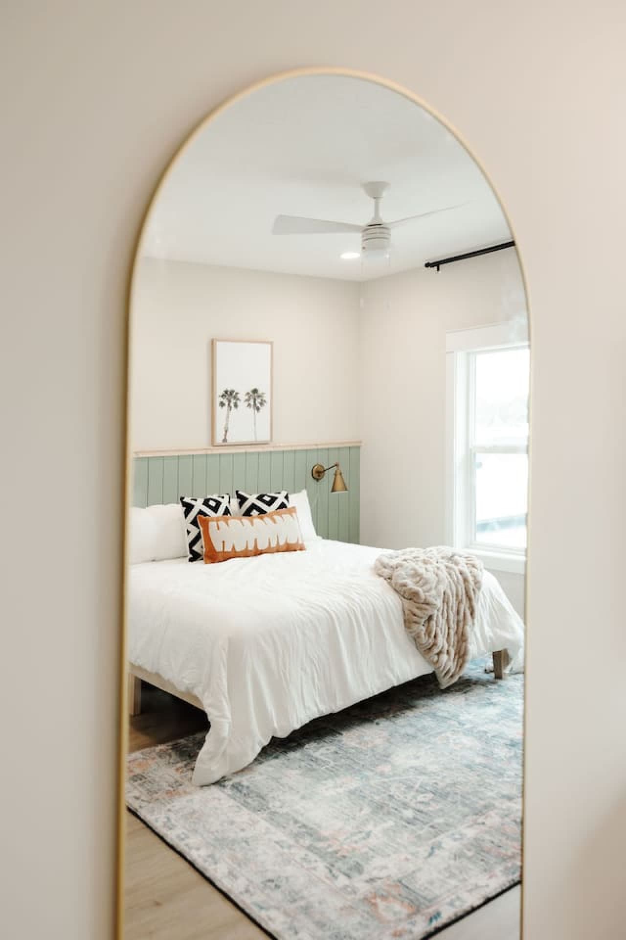A standing mirror available in the bedroom