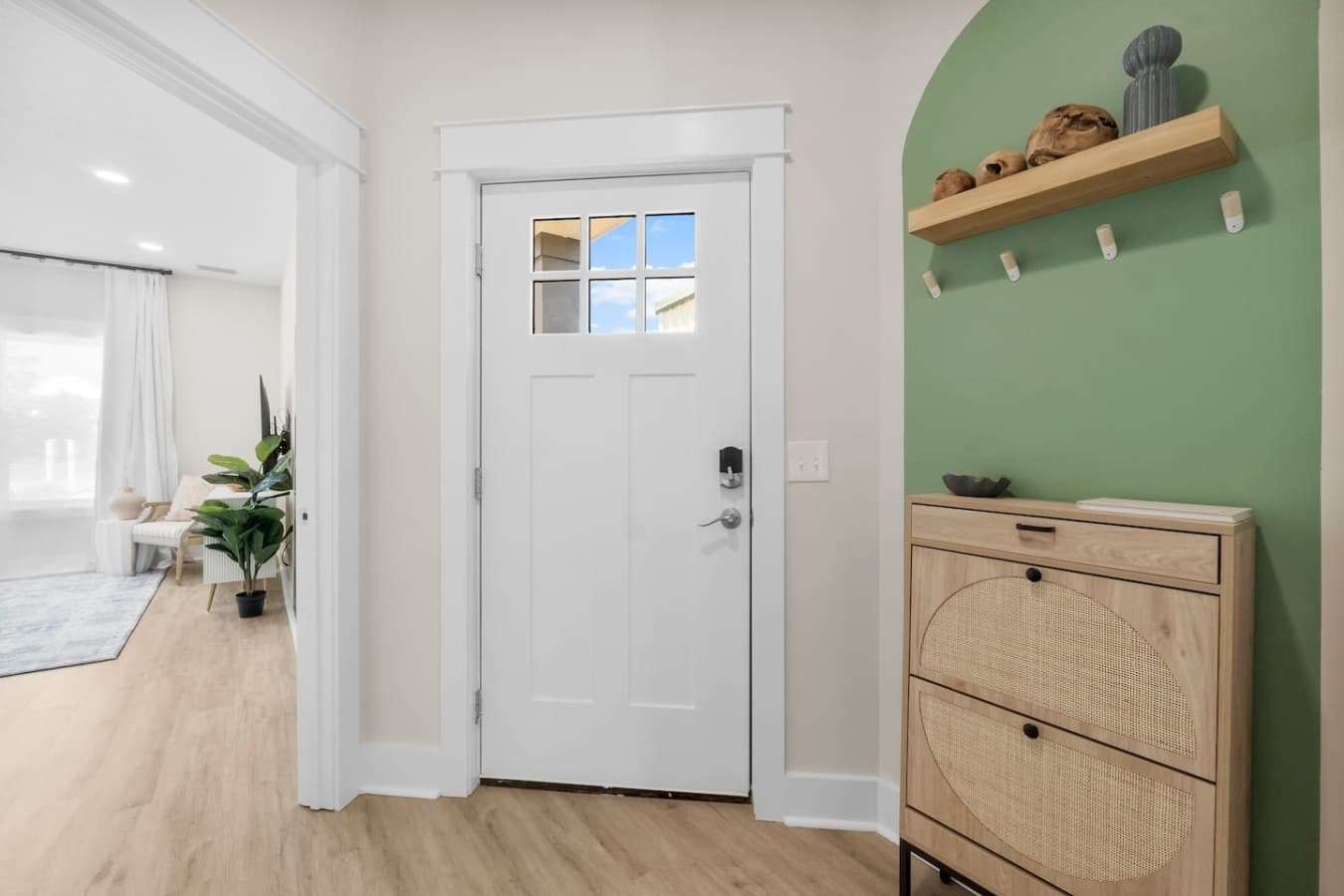A nice entryway with an smart door lock on the front door and main floor King bedroom to the left.