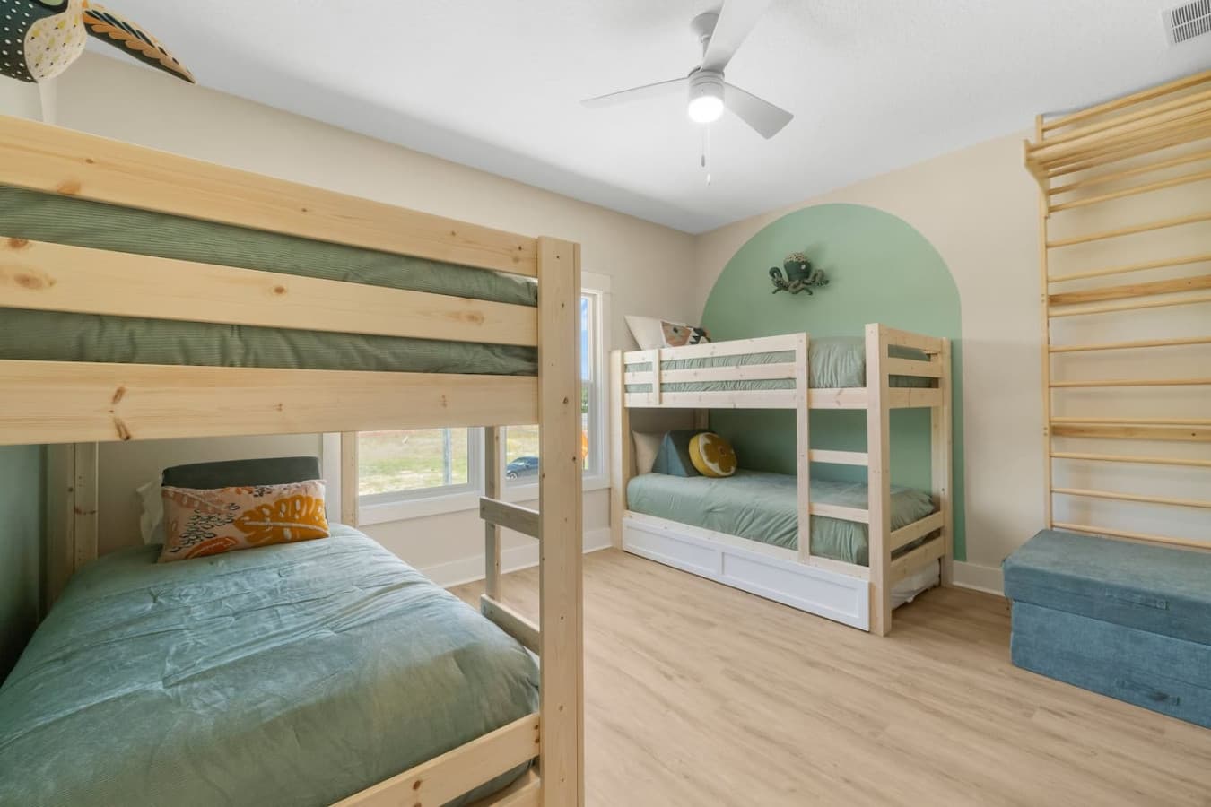 Bunk room for the kids with a fun design complete with a unique climbing wall!