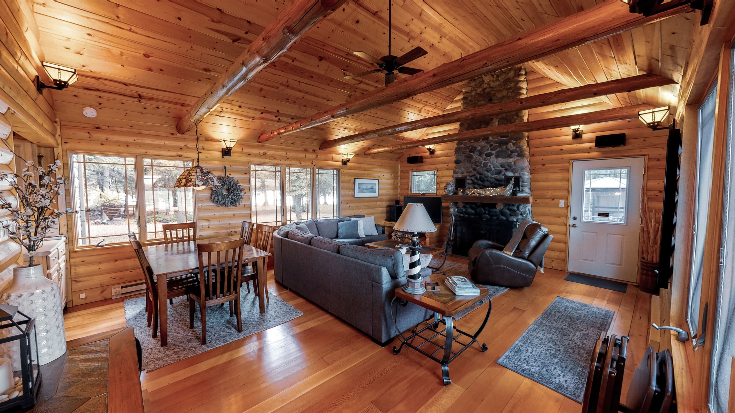 2 story stone fireplace and surrounded by lake views out the window make this a cozy place to settle in after a day on the lake.