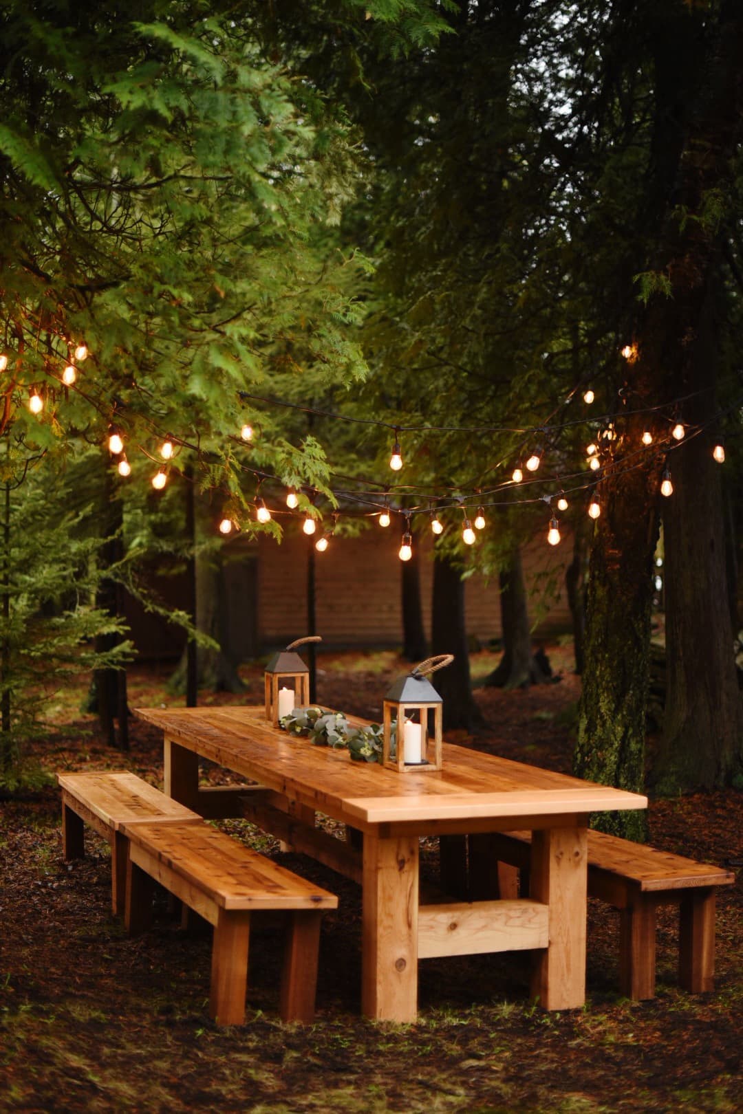 Large farm table for dinners al fresco under twinkly lights.