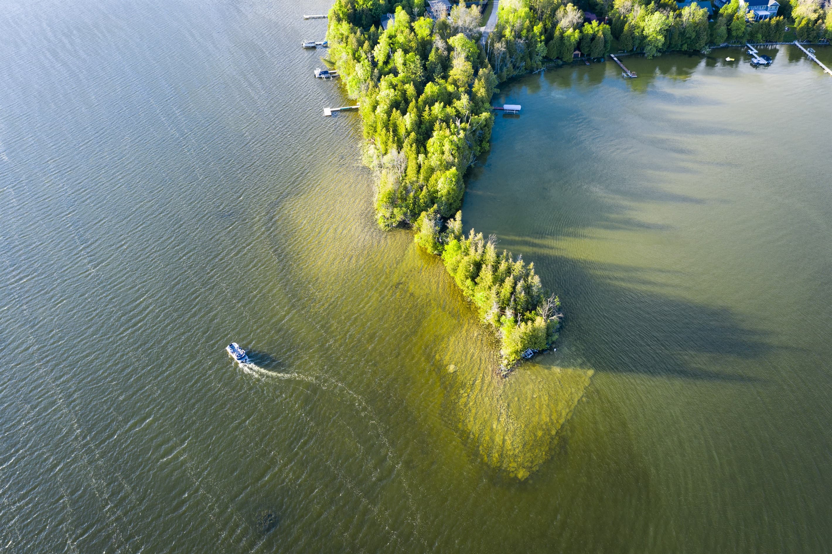 Located on a private peninsula, means 1200 feet of lake frontage and 360 degree views of the water at all times.