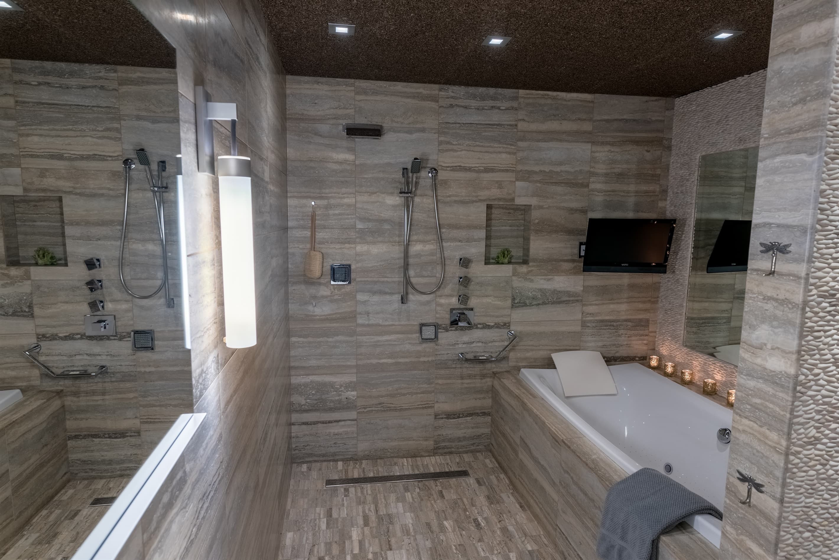 The third luxury bathroom offers a fully tiled room with multiple shower heads and jacuzzi with jets.