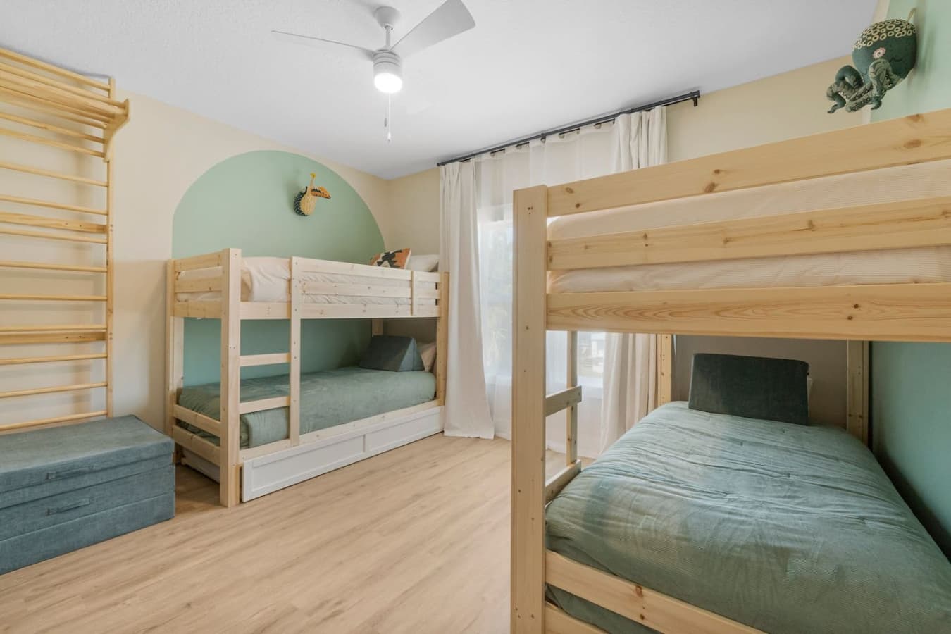 Bunk room for the kids with a fun design complete with a unique climbing wall!