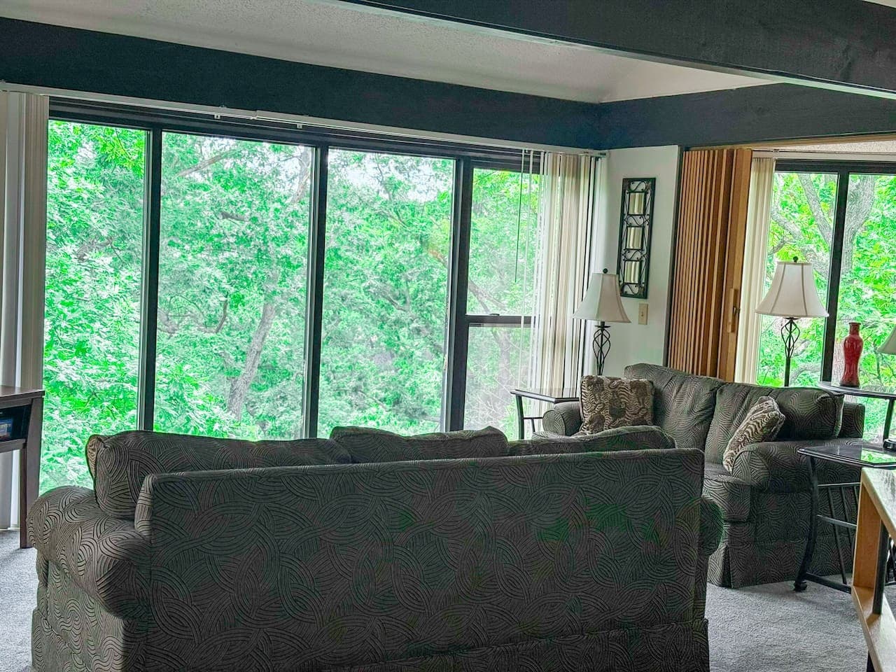 "Immerse yourself in nature's beauty! Expansive windows bring the stunning tree canopy right into your comfortable living space."