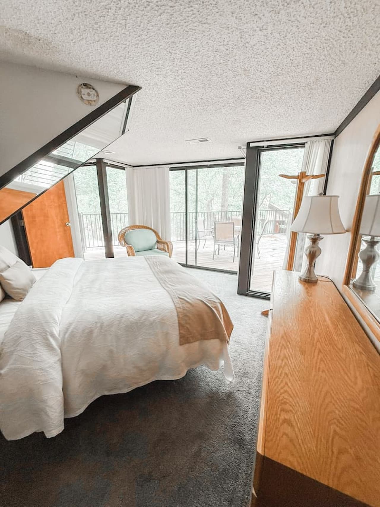 "This comfortable bedroom offers direct access to the outdoor deck, inviting you to step out and enjoy the fresh air anytime."