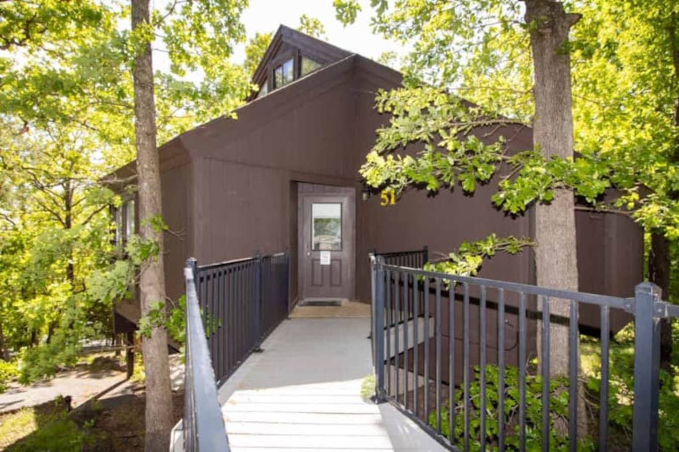 A warm welcome awaits—private path to your hillside hideaway in Treetop Village.