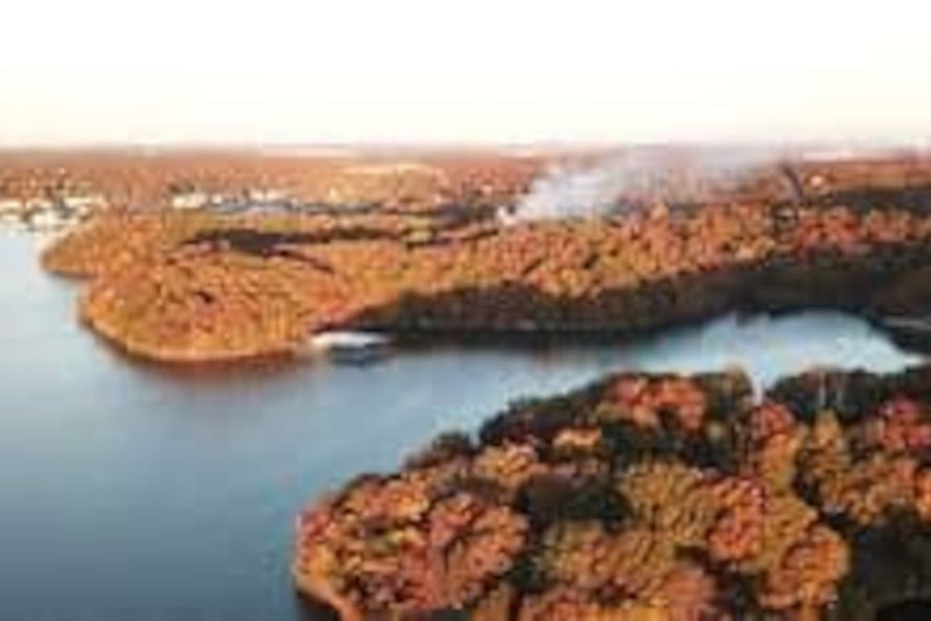 This stunning lakefront rental offers direct water access, perfect for boating and enjoying scenic views. Surrounded by lush greenery, it's an ideal retreat for those seeking tranquility and outdoor adventures.