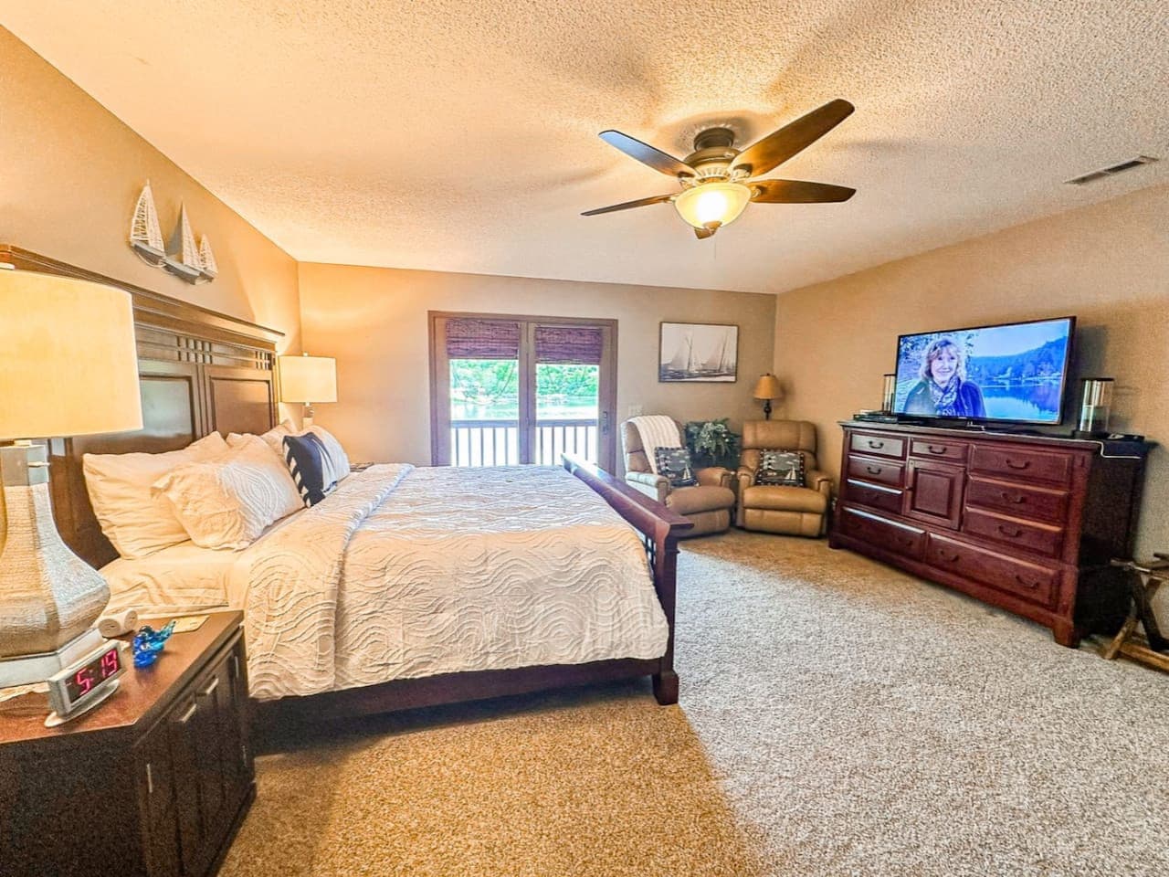 Wake up to lake views and cozy comfort in this spacious master suite—perfect for relaxing after a day on the water.