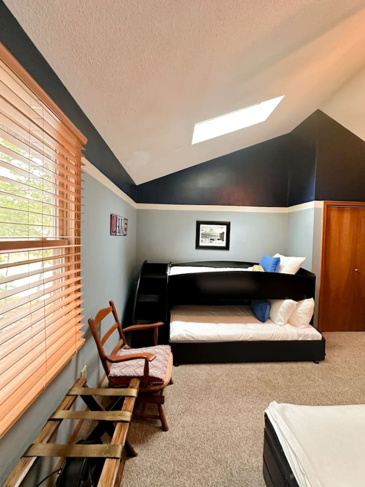 Welcome to your cozy retreat! This modern bedroom features a sleek bunk bed, warm lighting, and skylights for a bright, relaxing stay—perfect for unwinding after a day of adventure.