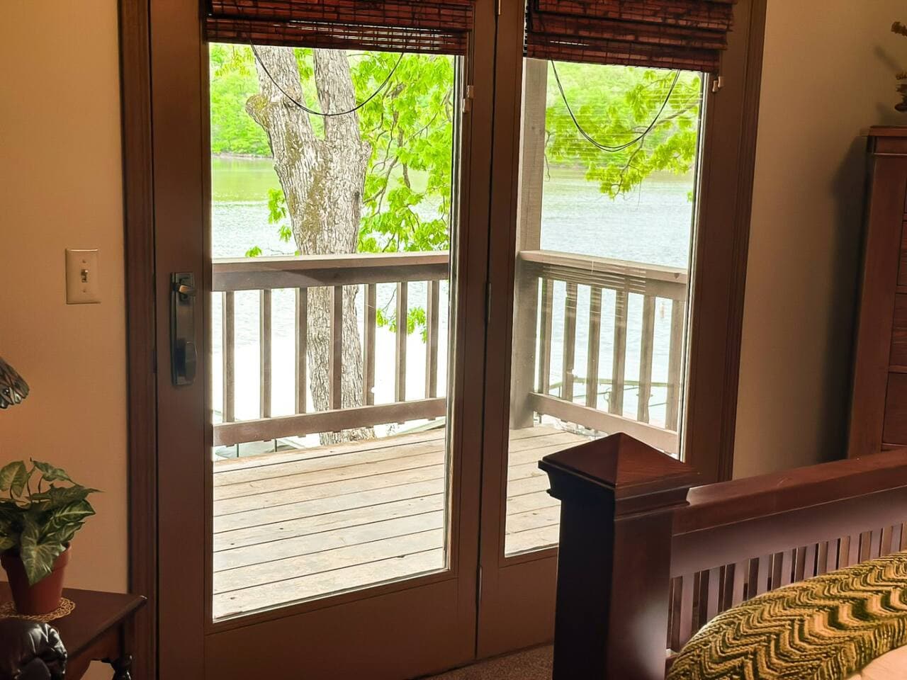 Wake up to breathtaking lakefront views in this serene bedroom, complete with a private balcony perfect for morning coffee or evening stargazing. Large windows and natural light make the space feel airy and peaceful, blending indoor comfort with outd