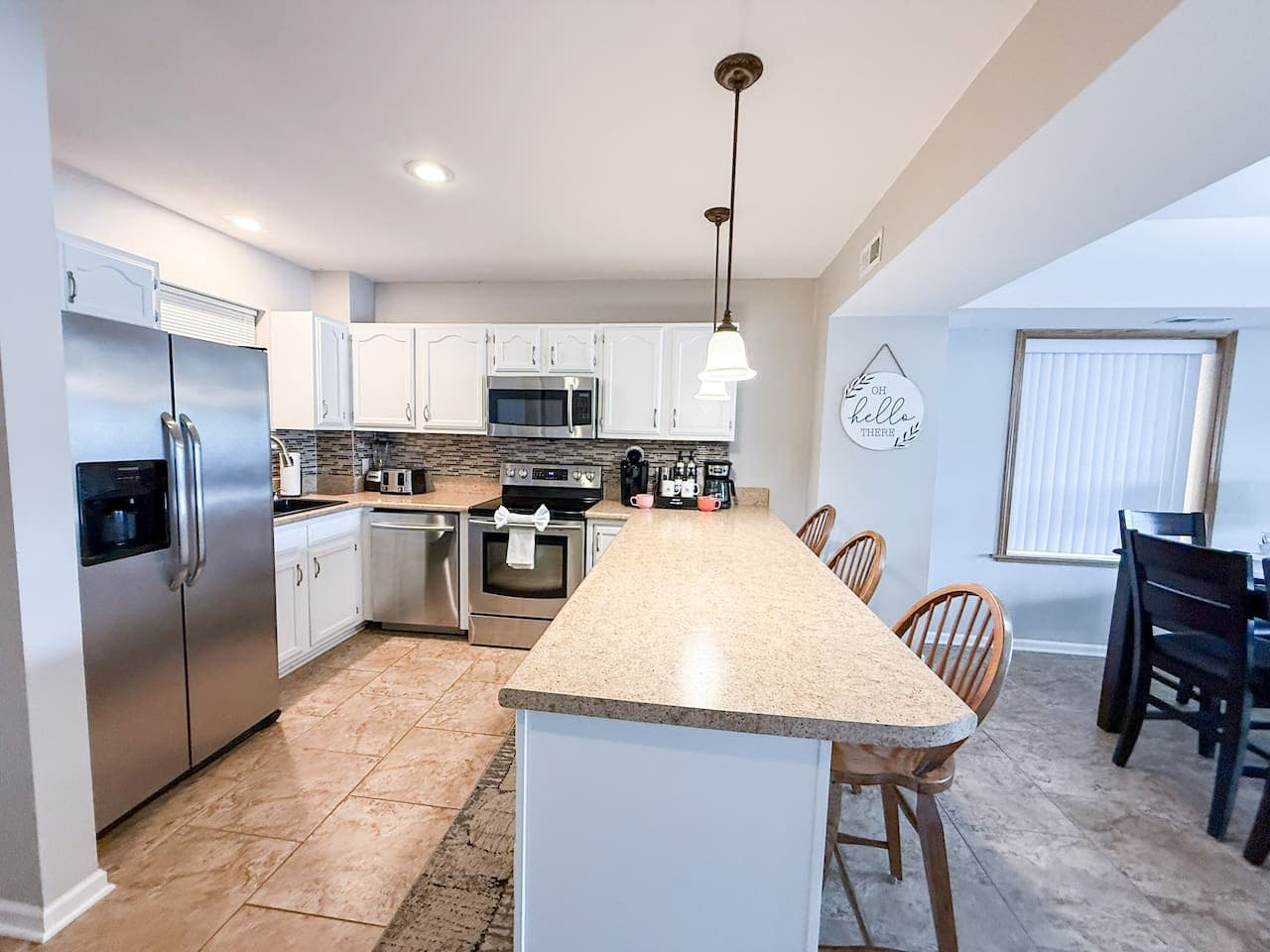Seamless flow from the fully stocked kitchen to the dining area, perfect for enjoying meals and company during your stay.