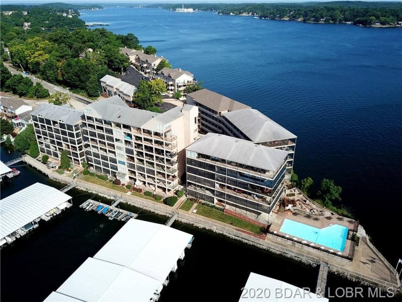 Experience incredible waterfront living at this lakeside property, featuring a beautiful pool and direct lake access.