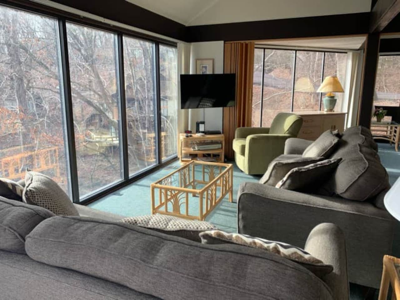 Bright and spacious living area with breathtaking lake views! Whether you're curling up with a book, sipping your morning coffee, or gathering for a cozy movie night