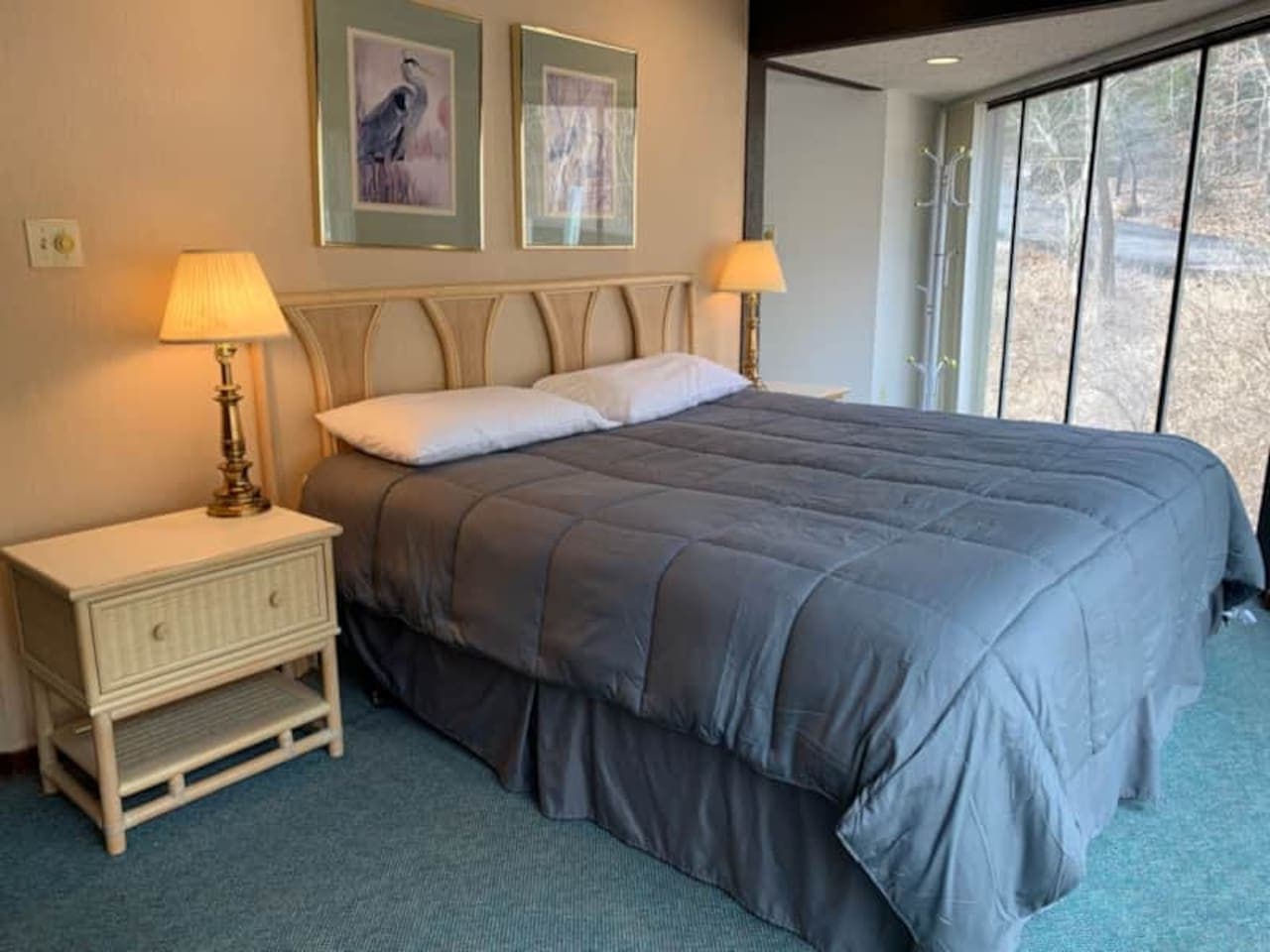 Drift into restful sleep while surrounded by breathtaking nature views, framed perfectly through expansive floor-to-ceiling glass windows. Wake up to the beauty of the outdoors from the comfort of your cozy retreat.
