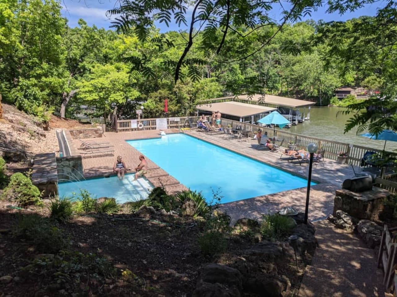 This exceptional property boasts a private pool and spacious deck, perfectly situated directly on the lake with convenient boat dock access. Enjoy endless summer days by the water, whether swimming, sunbathing, or embarking on aquatic adventures righ