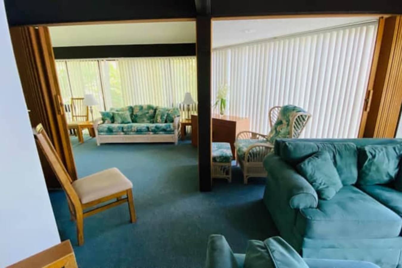 Cozy living room! The mix of seating arrangements creates a welcoming and relaxed vibe. The large windows let in plenty of natural light, making the space feel open and airy.