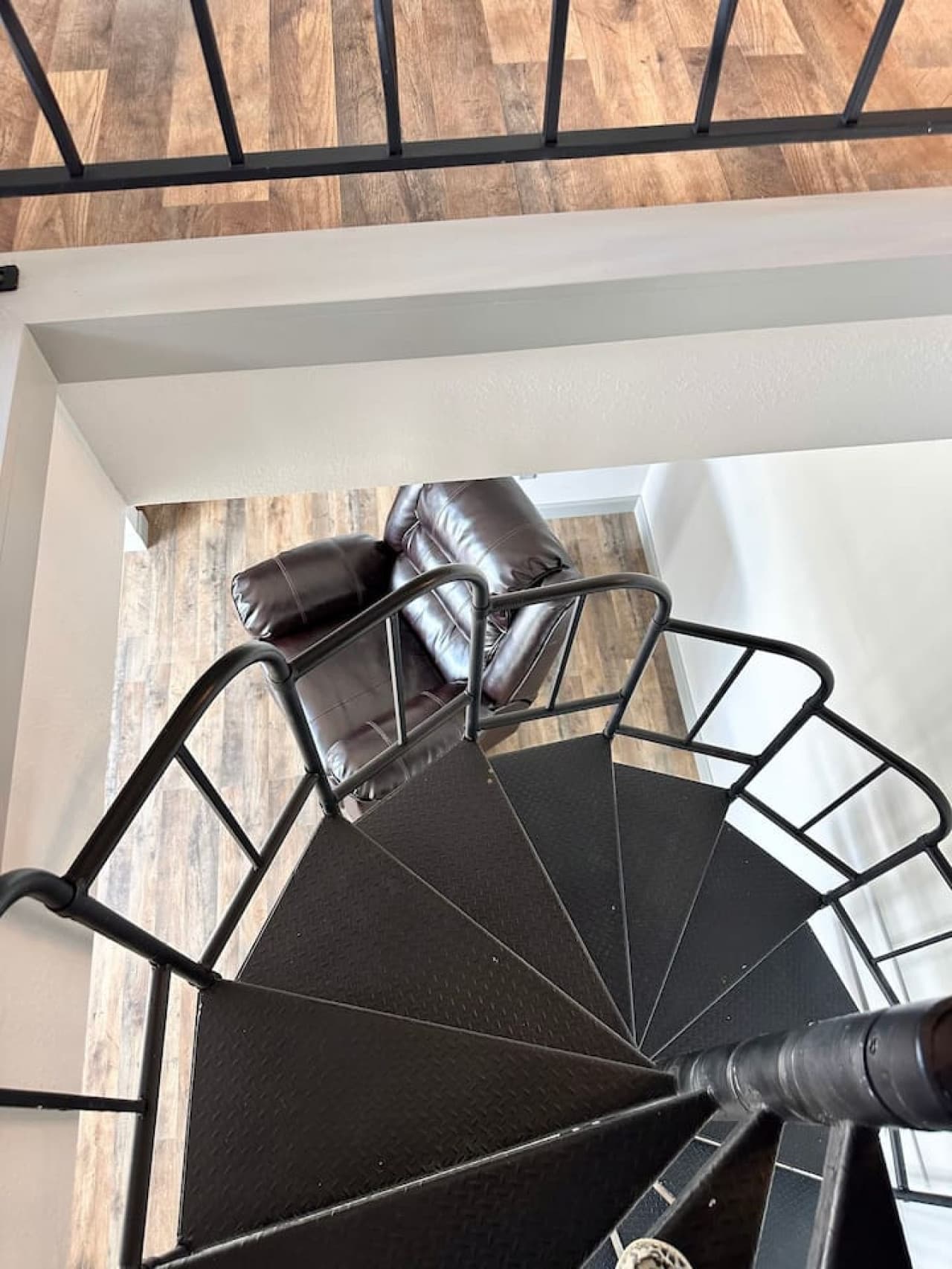 Beautiful staircase leading to the first floor, adding charm and flow to the condo’s layout. A stylish entryway to your cozy main living spaces below.