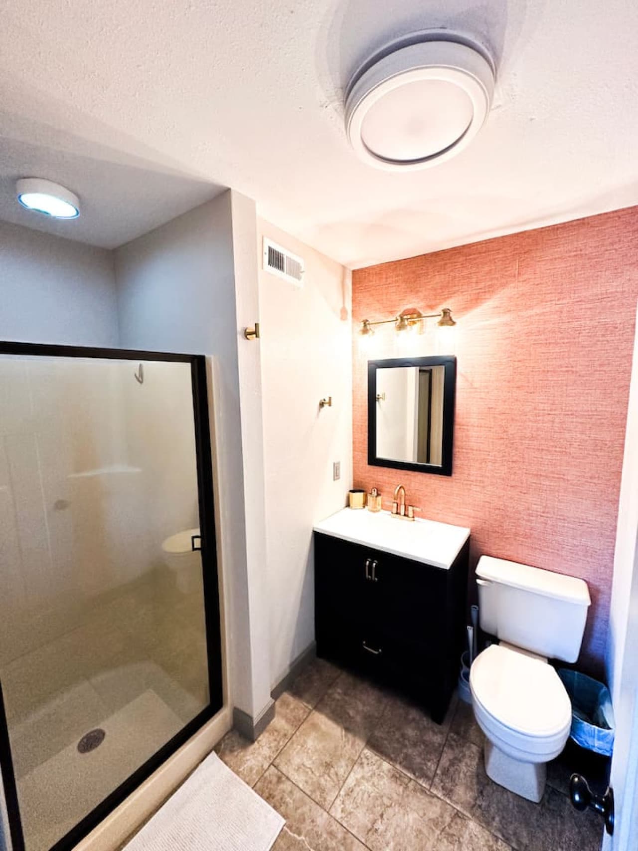 Step into a sleek bathroom featuring a spacious shower, perfect for a refreshing start or relaxing end to your day.