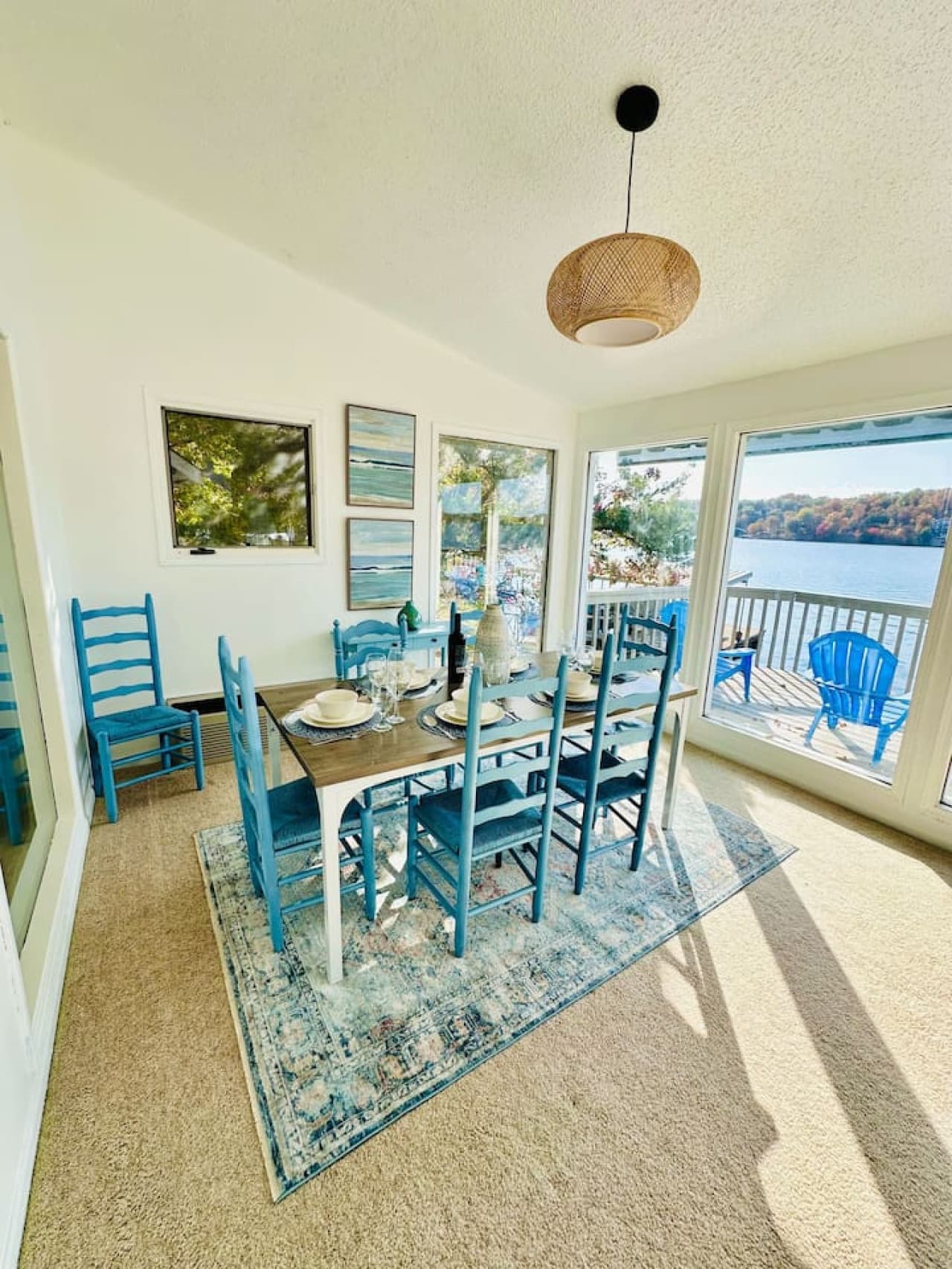 Bright dining space with expansive windows framing the lake.
