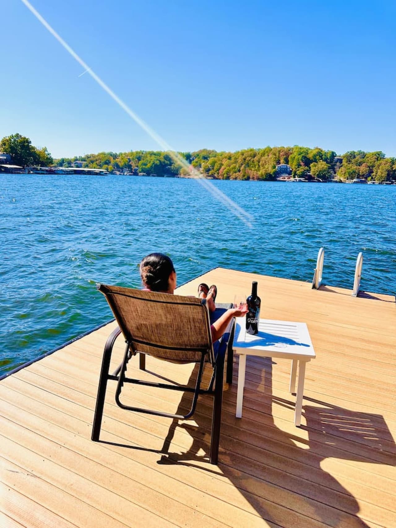 Unwind with a glass of wine on your private dock—where every sip comes with a view.