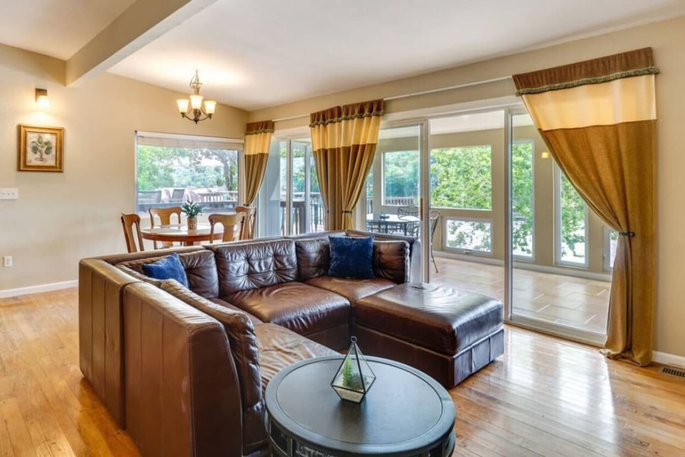 Comfortable seating area with expansive windows, bringing in natural light and offering stunning lakefront scenery.