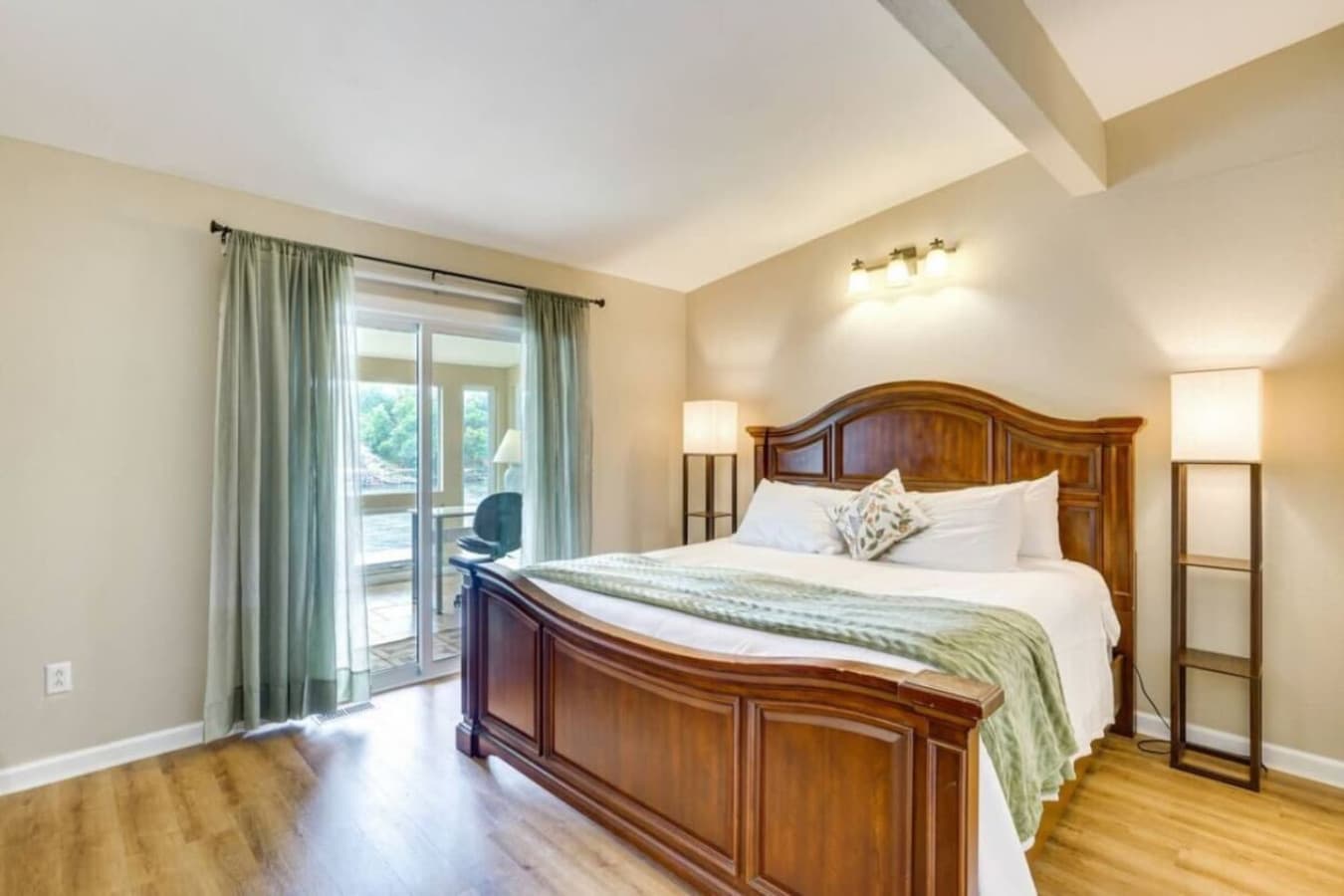 The master bedroom offers direct access to the deck, blending indoor comfort with stunning outdoor views.