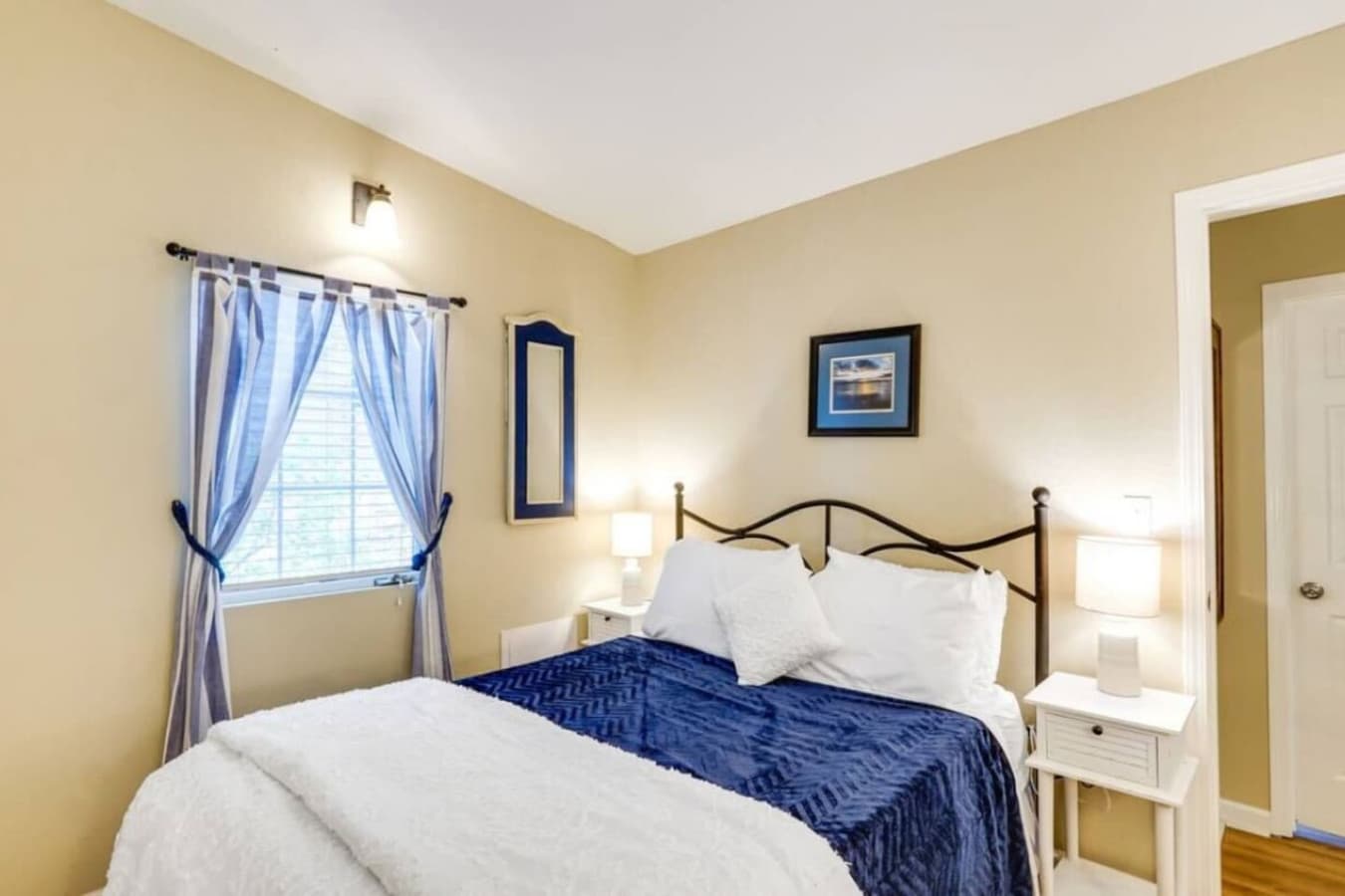 A cozy and inviting bedroom featuring a comfortable bed with blue accents, perfect for relaxation after a day by the lake.