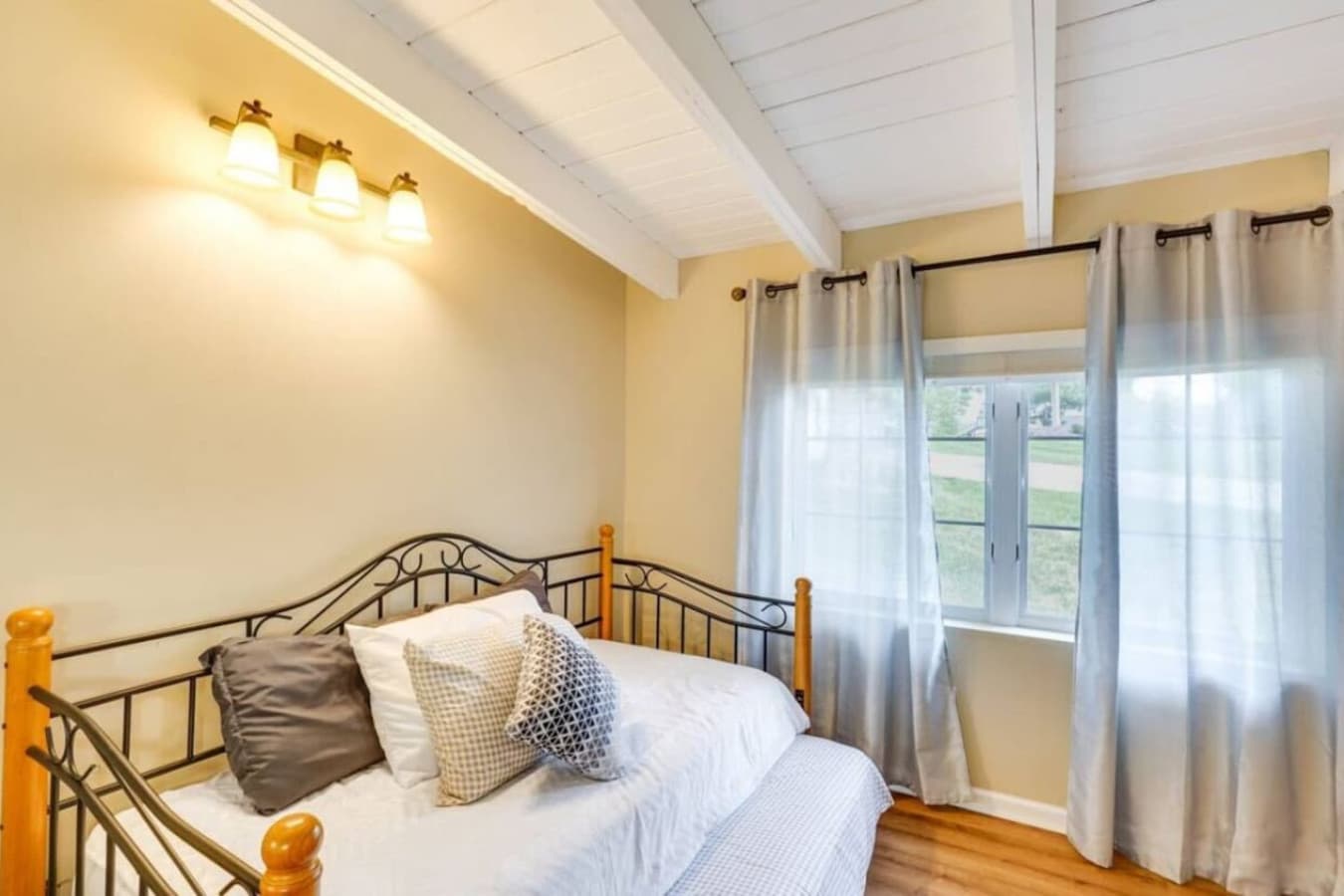 A bright guest room with plenty of natural light and comfortable bedding.