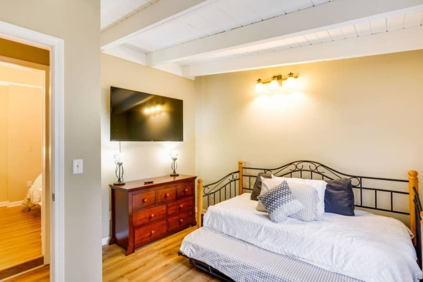 A cozy room with a daybed and a large TV, perfect for relaxing or hosting extra guests.
