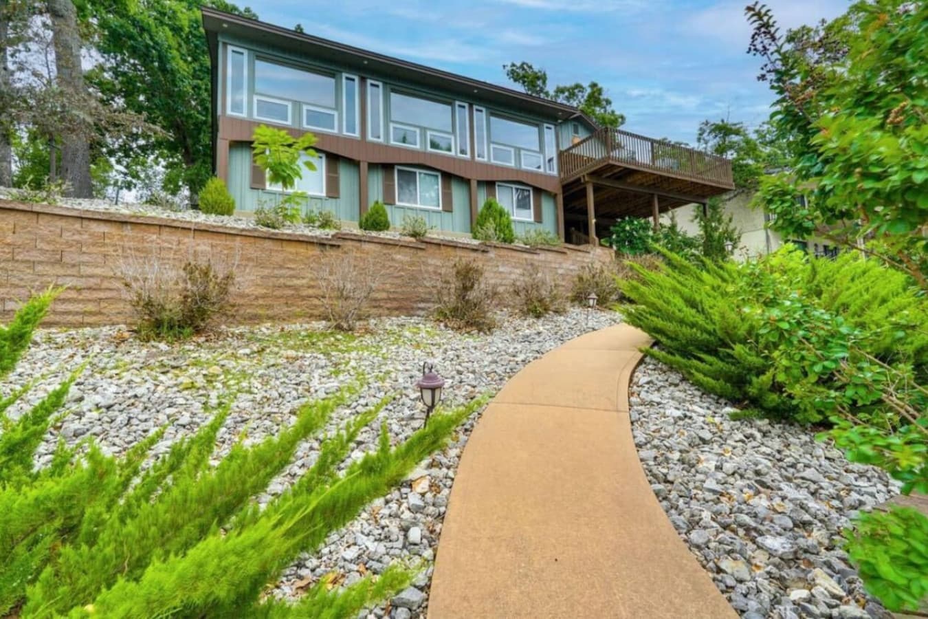 A charming pathway surrounded by greenery welcomes you to the property.