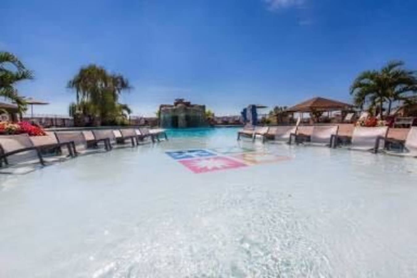 Sun-soaked and serene—dip your toes in the shallow lounge pool surrounded by palm trees and lake breezes.