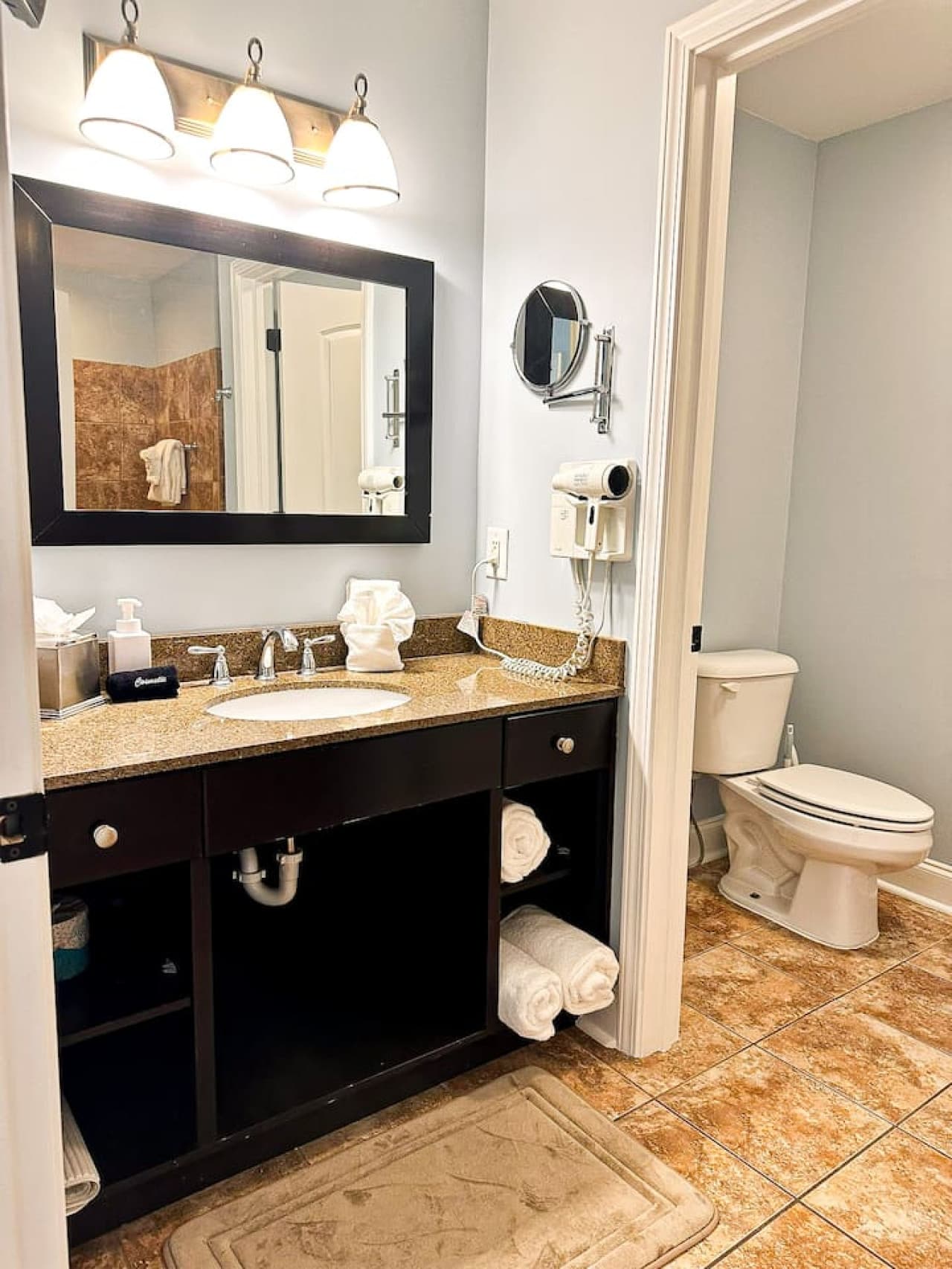 Fresh towels, bright lighting, and thoughtful touches—your ensuite bathroom is stocked and ready for a relaxing stay.