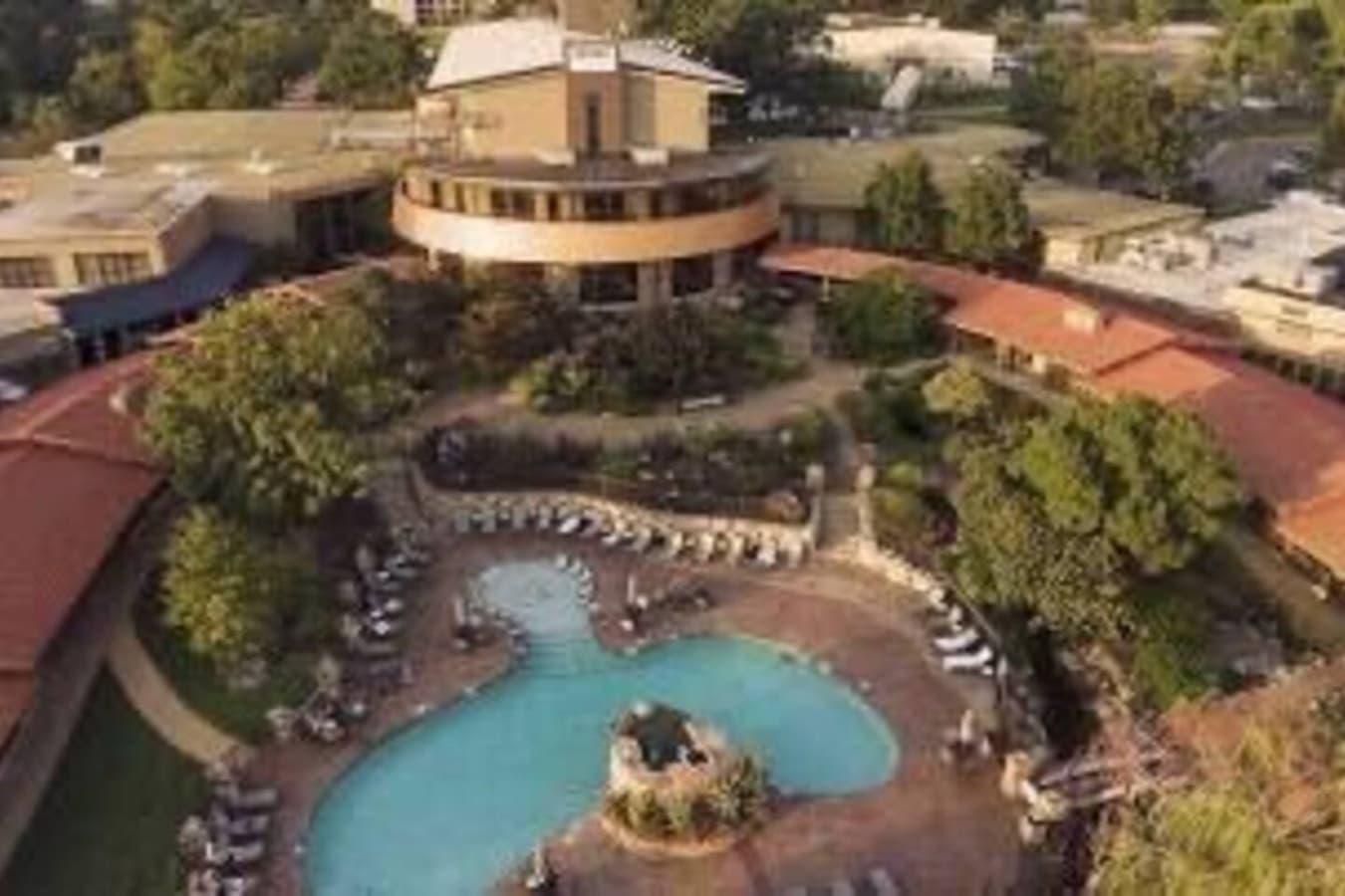 "Resort-style pool surrounded by lush landscaping and comfortable loungers—ideal for relaxing all day long."