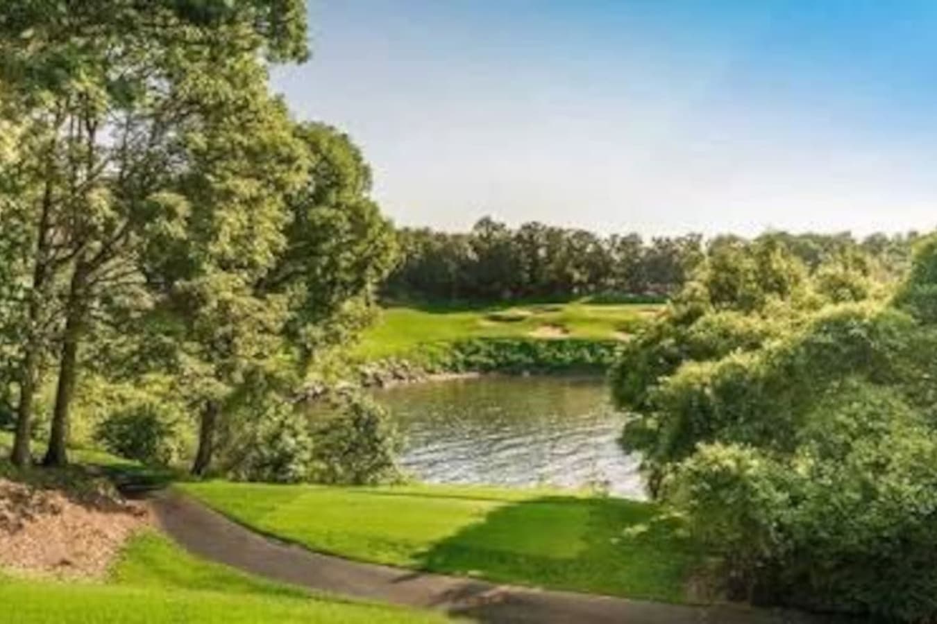 "Play through rolling fairways framed by water and woods at the Four Seasons’ championship golf course."