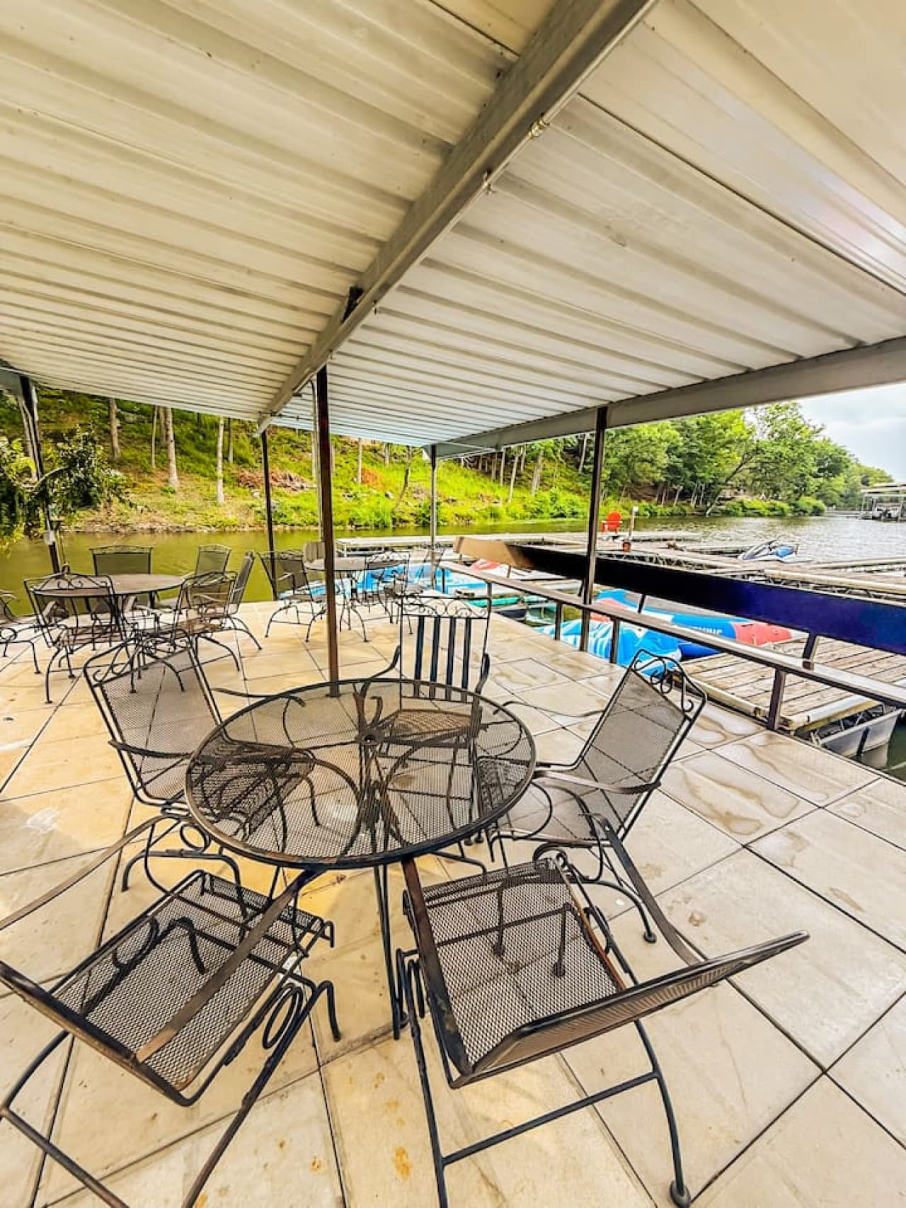Enjoy a covered swim dock with plenty of seating, perfect for lounging, swimming, and lake views. Stay shaded while relaxing by the water—ideal for gatherings and picnics.
