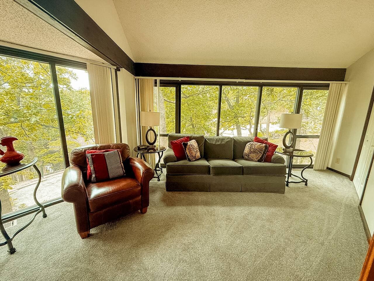 Escape into a peaceful retreat with a spacious living room designed for quiet evenings and reading sessions. Windows frame a breathtaking lakeview, the perfect backdrop for unwinding with a good book or simply soaking in the serene surroundings.