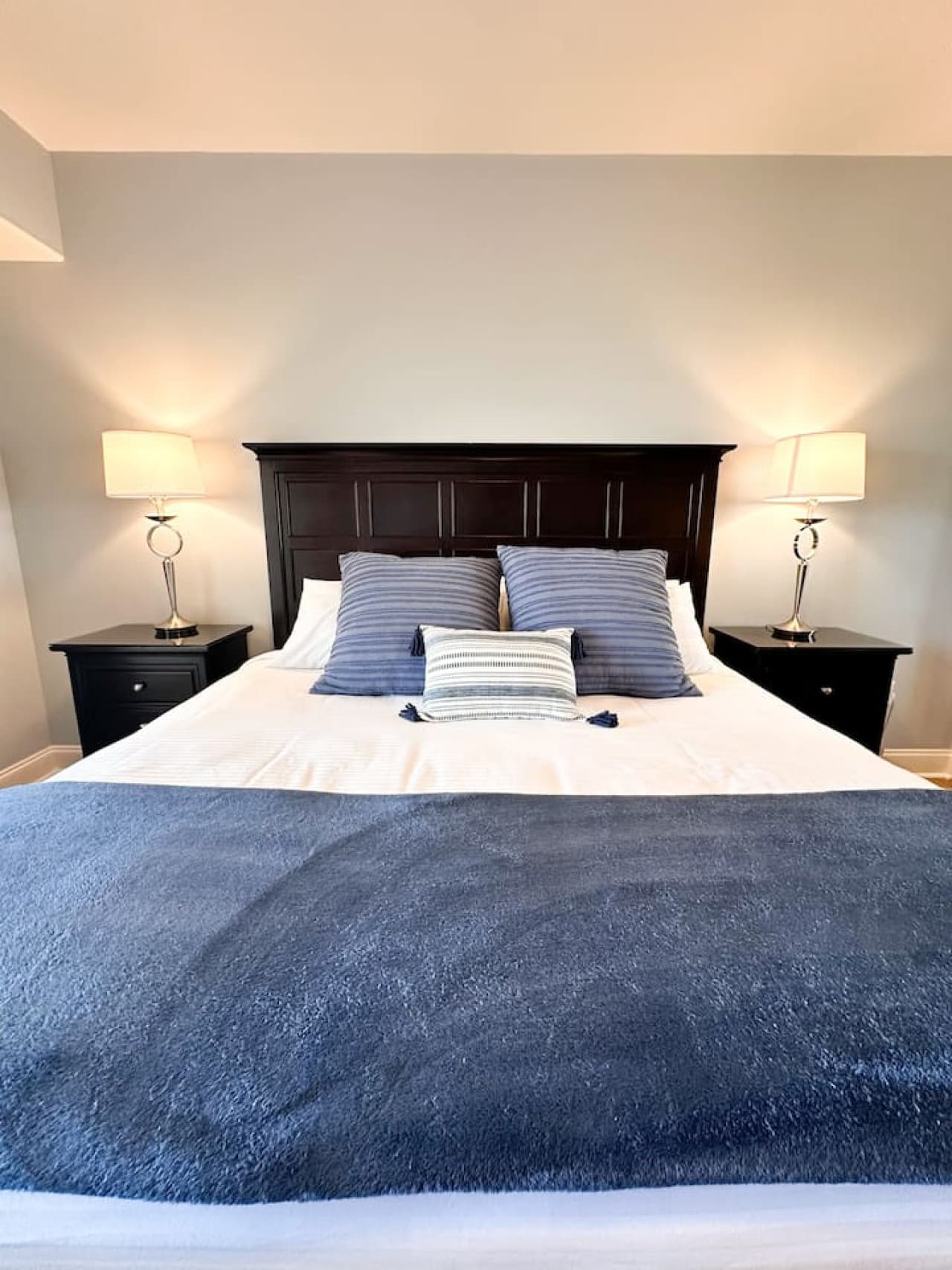 A well-prepared bedroom with quality linens and lighting