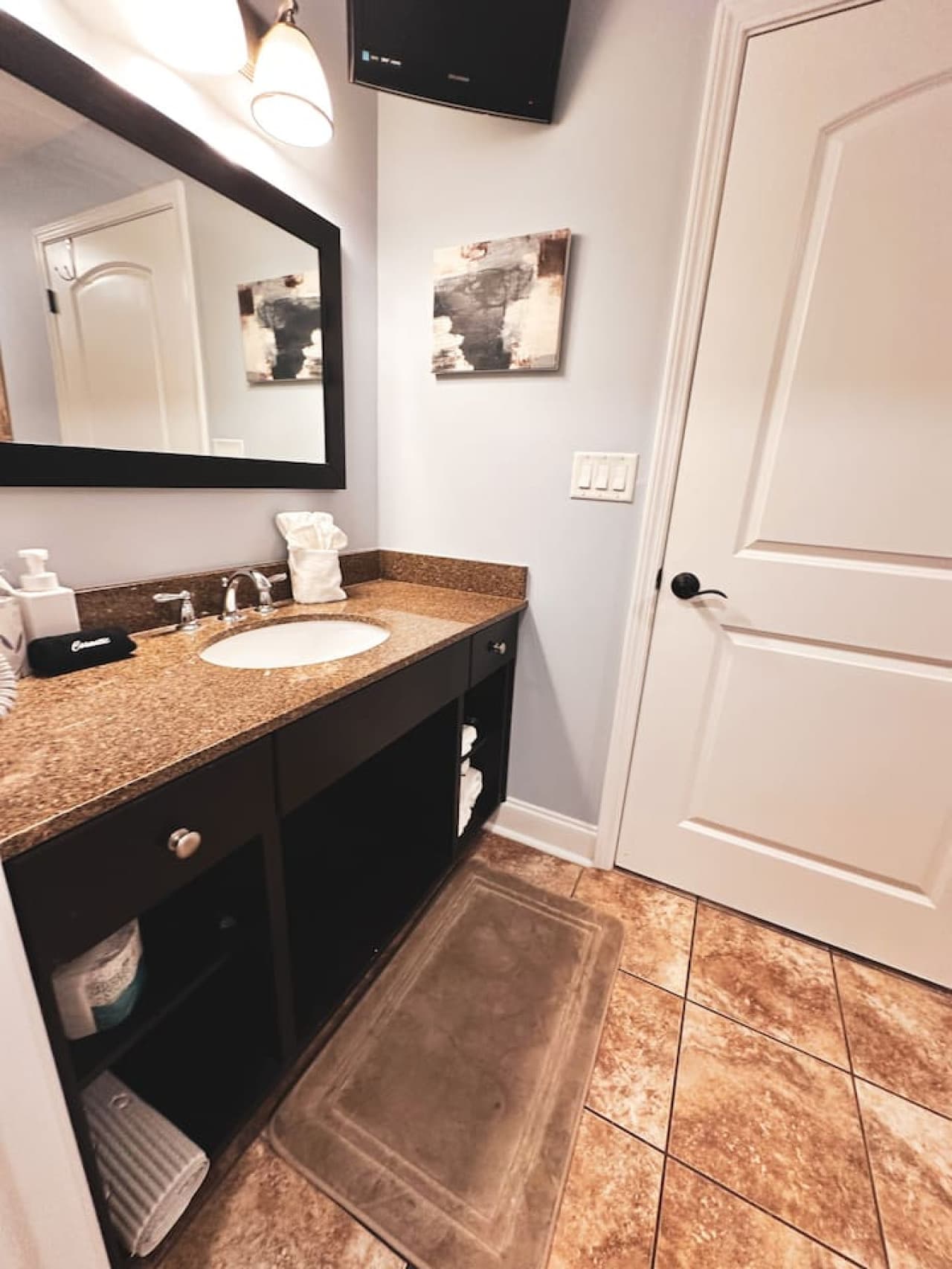 Featuring a well-lit vanity, plush towels, and essential amenities to make your stay comfortable.