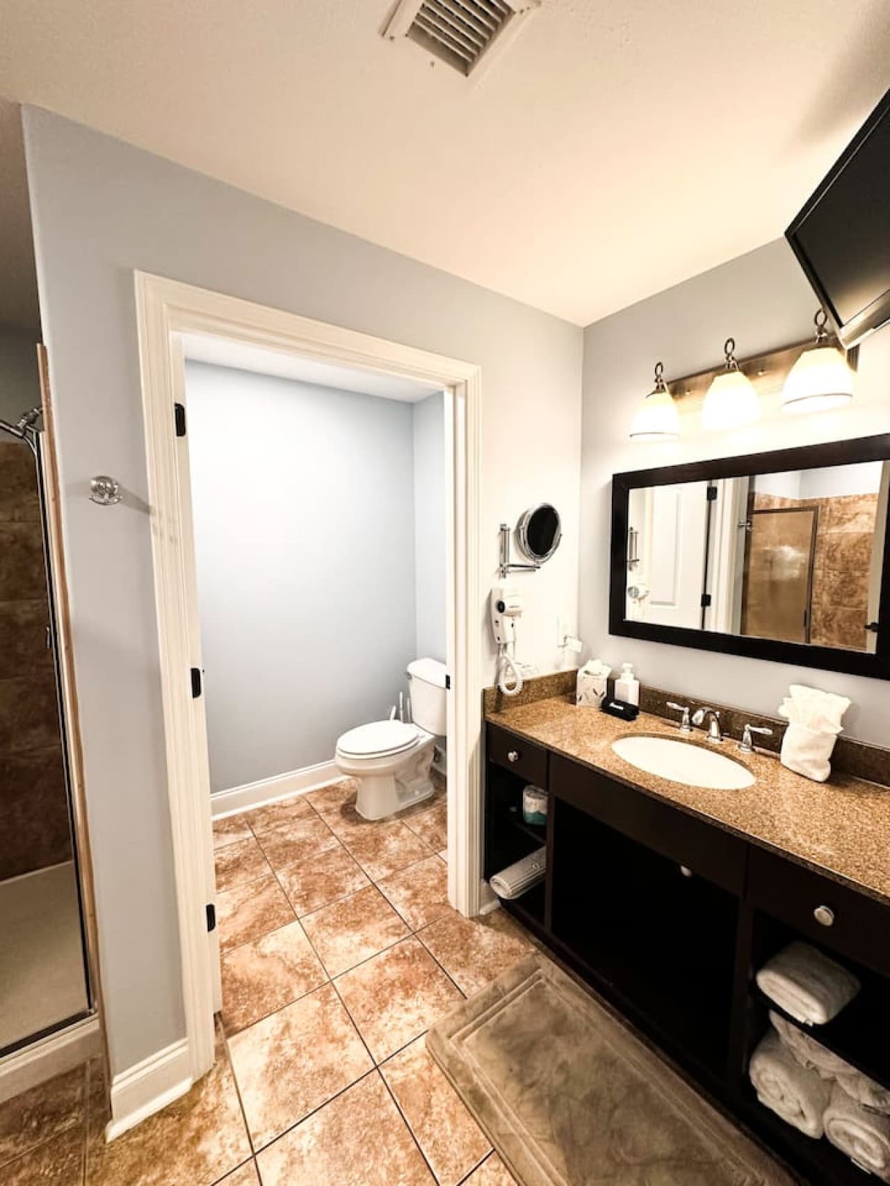 Thoughtfully equipped with a spacious shower, soft lighting, and essential toiletries for a refreshing experience.