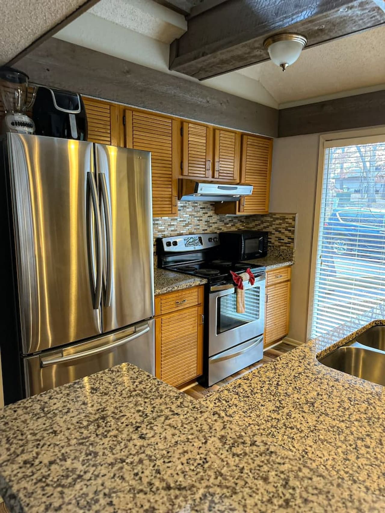 "Cook like a pro in this fully equipped kitchen, featuring sleek stainless steel appliances and granite countertops!