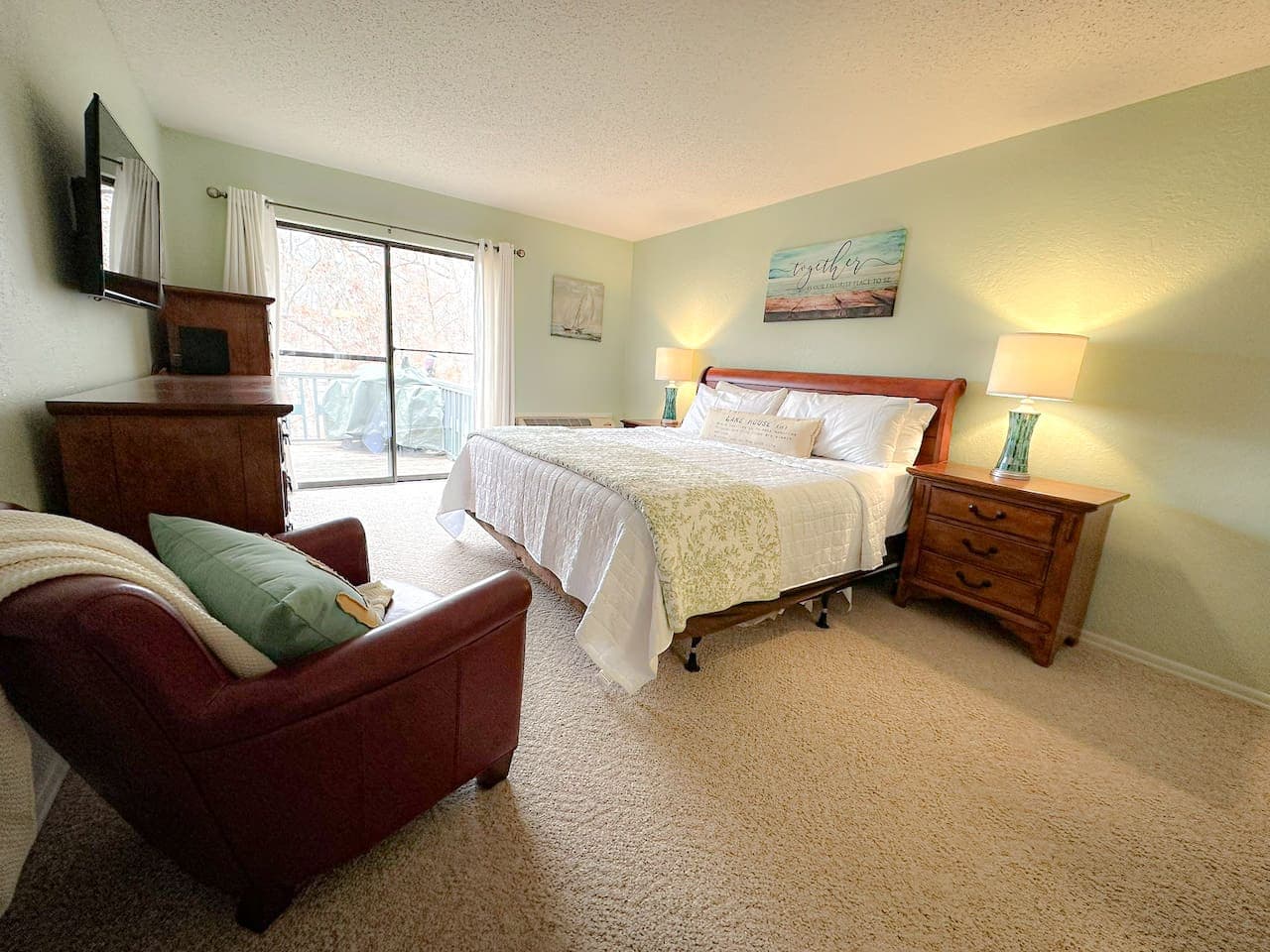 Relax in the master suite with a king-sized bed, private deck access, and calming decor.