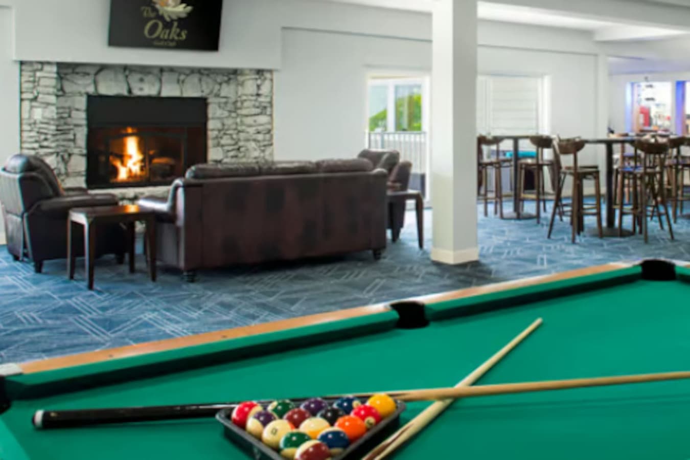 Game on! Enjoy a round of billiards or relax by the cozy fireplace in this inviting space.