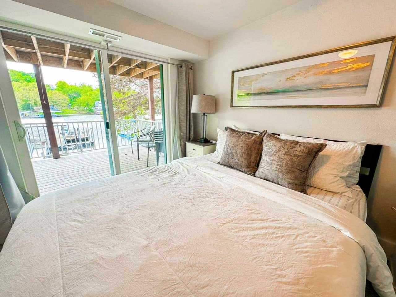 Private master bedroom on first floor with king bedroom and private lakeview with access to patio deck