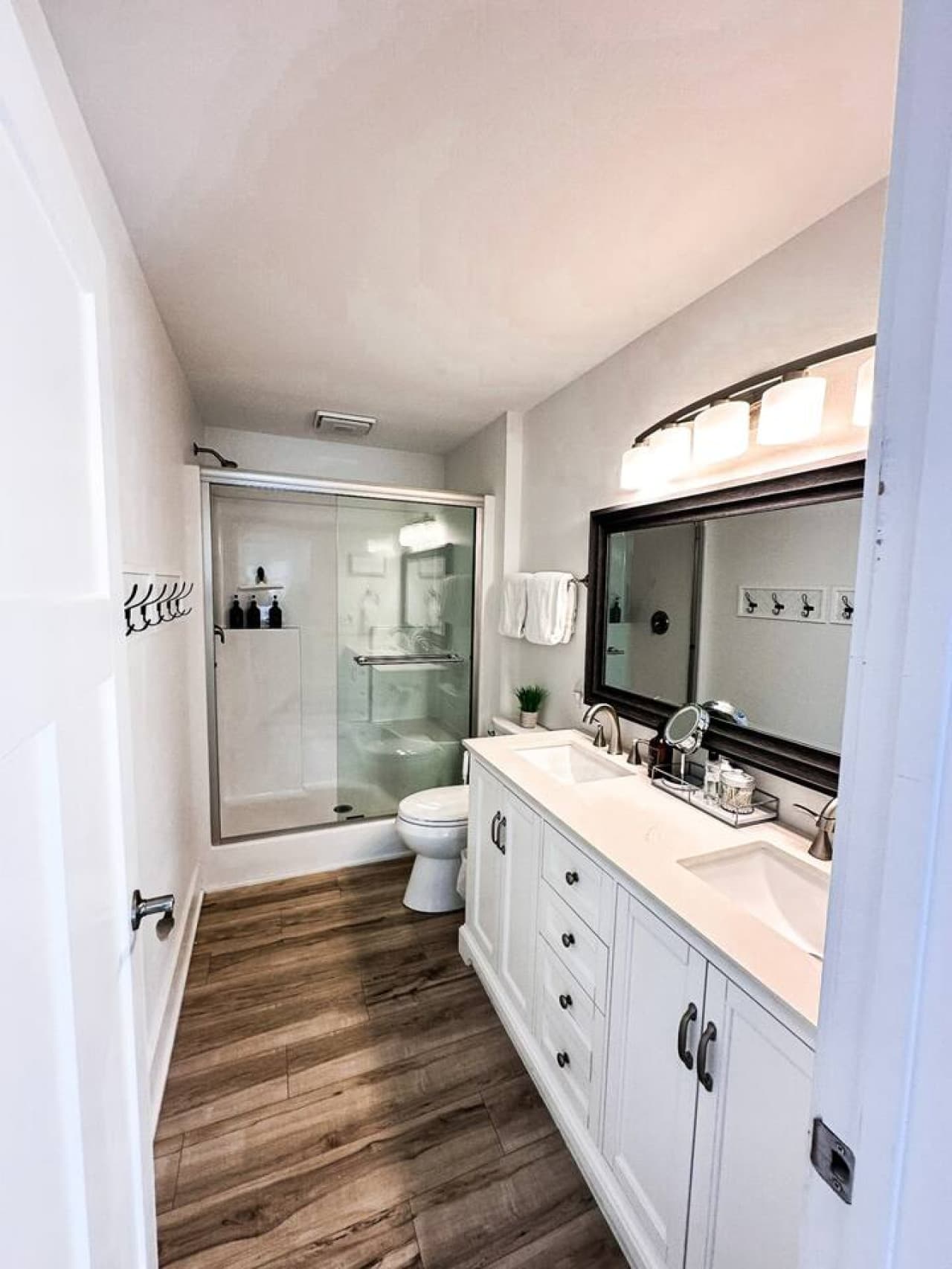 Mainfloor upper level bathroom with double vanity and walkin shower.